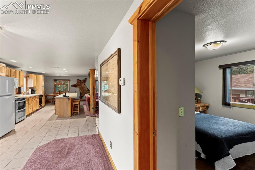 Image 25 of 42: Hallway to laundry room, bedrooms and bathrooms