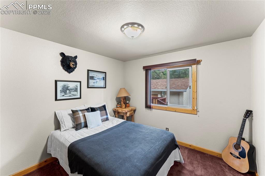 Image 26 of 42: Carpeted bedroom with a textured ceiling