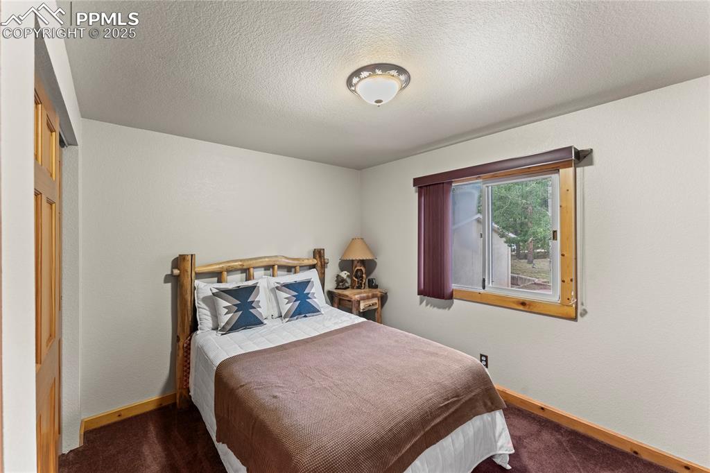 Image 31 of 42: Bedroom featuring carpet and a textured ceiling
