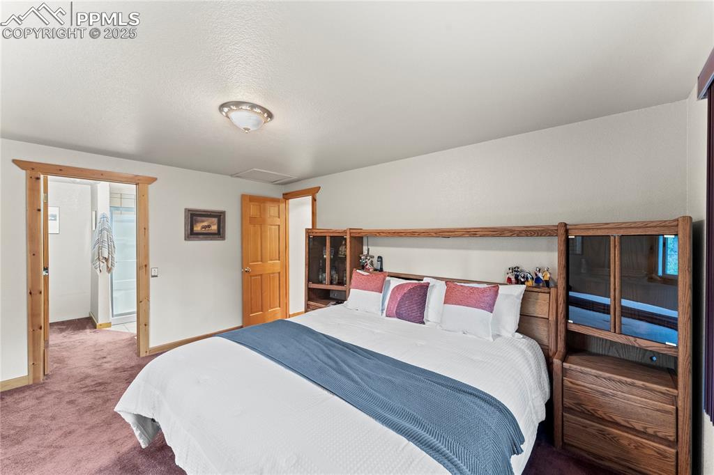 Image 33 of 42: Carpeted bedroom featuring attic access and baseboards