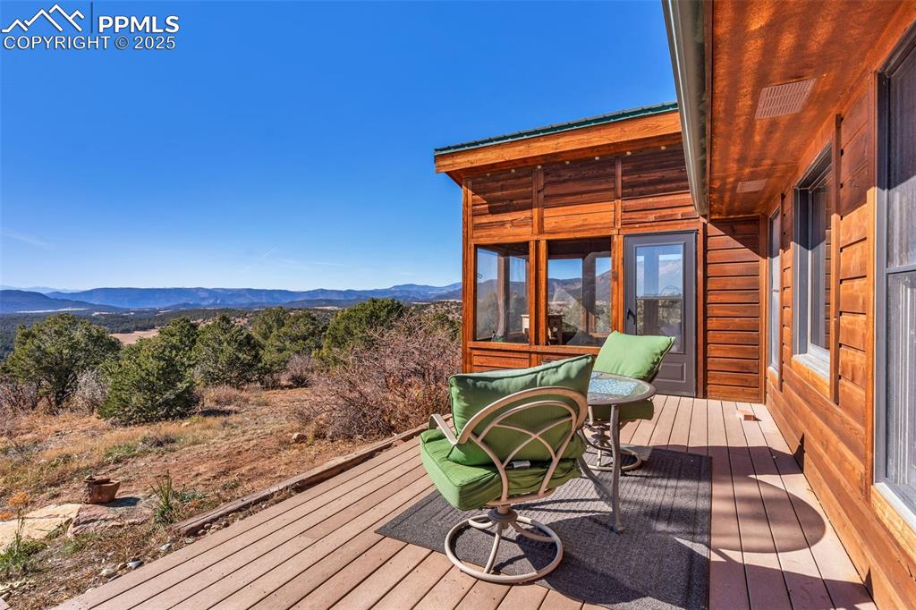 Image 35 of 50: Deck with a sunroom and a mountain view