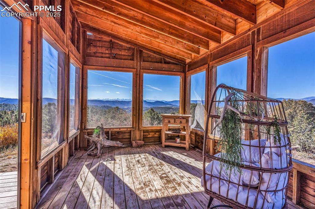 Image 36 of 50: Sunroom / solarium with a mountain view and wood-type flooring