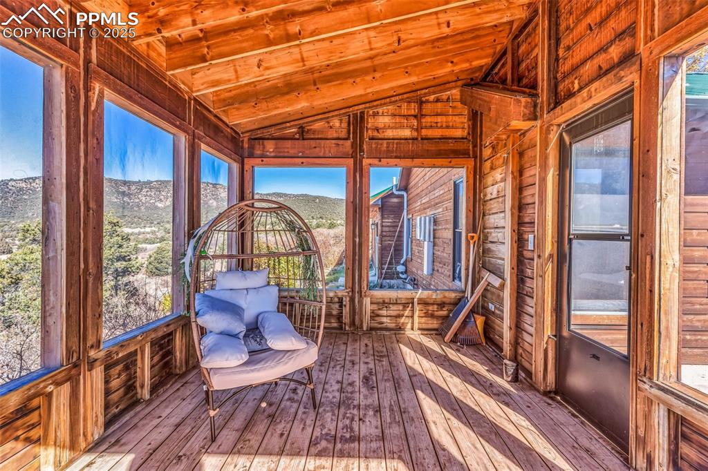 Image 37 of 50: Unfurnished sunroom with lofted ceiling and a mountain view