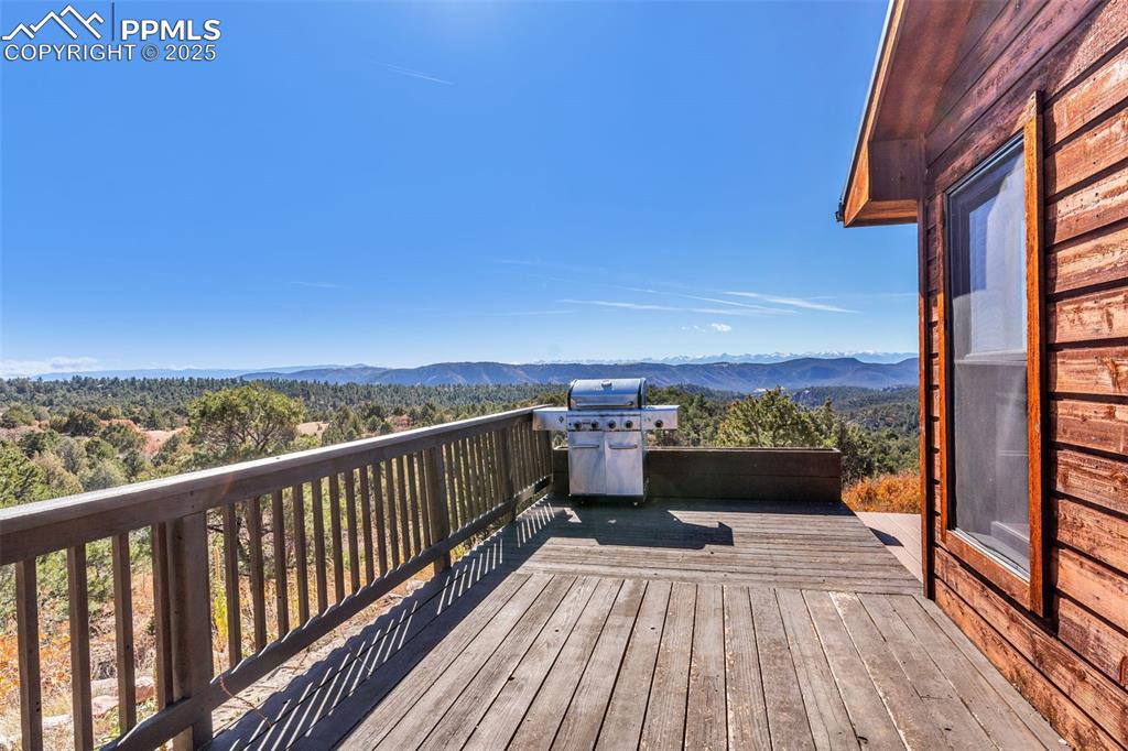 Image 40 of 50: Wooden terrace with a mountain view and area for grilling