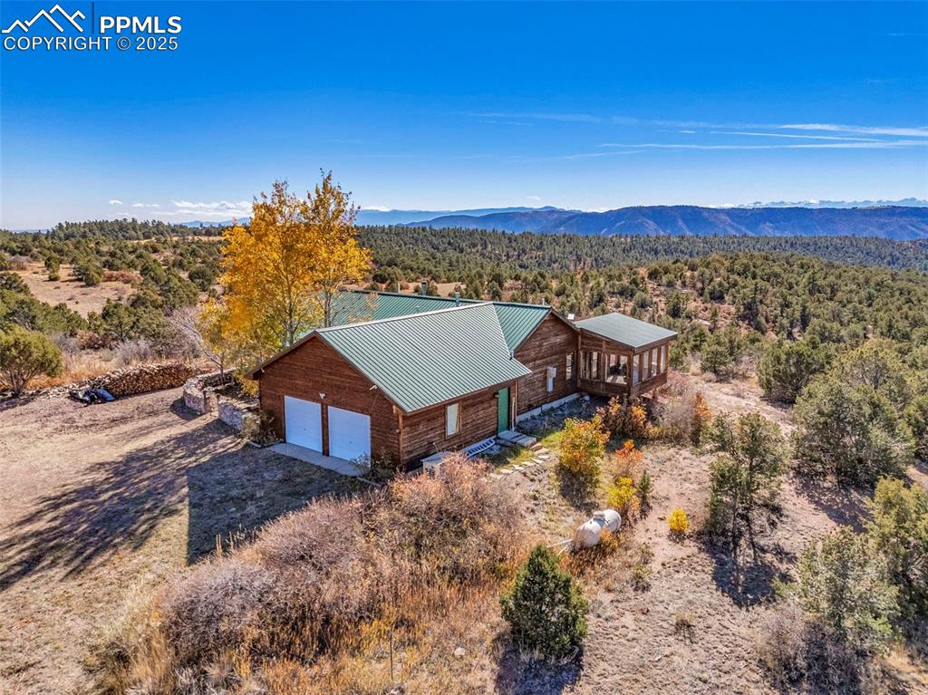 Image 42 of 50: Aerial view of property and surrounding area featuring a mountain backdrop 