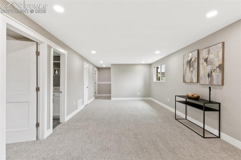 Image 16 of 18: Below grade area featuring carpet and recessed lighting