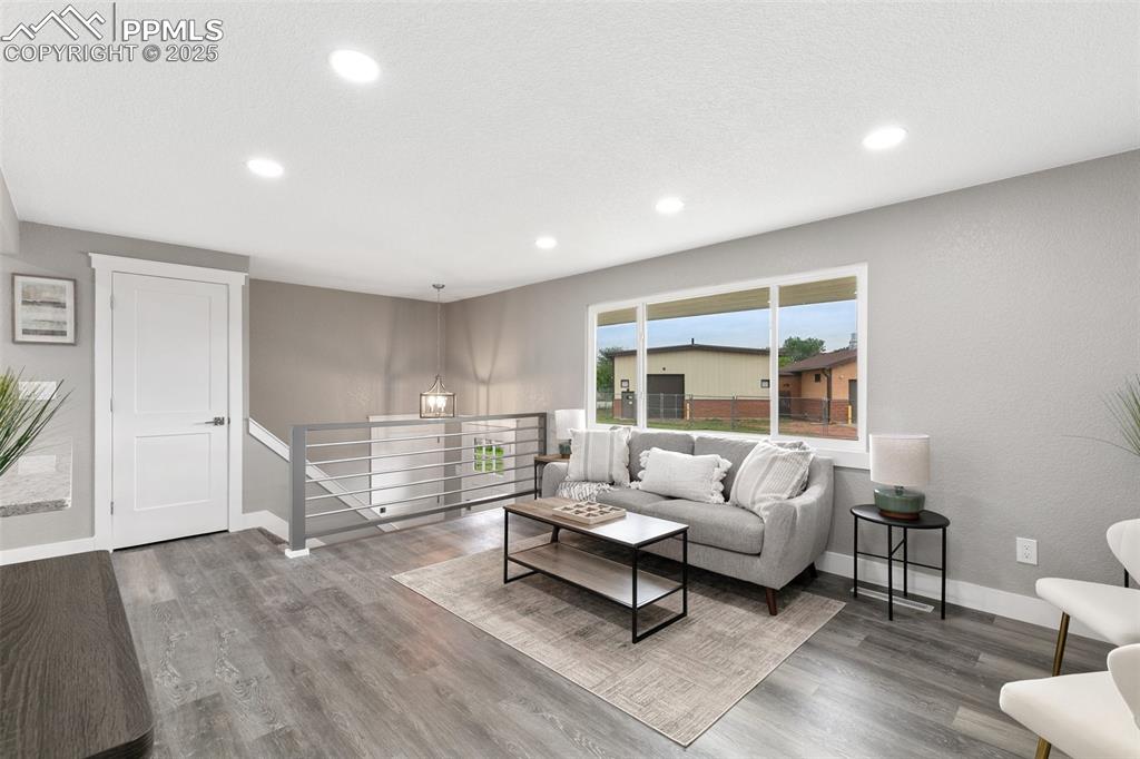 Image 5 of 18: Living area featuring recessed lighting and wood finished floors