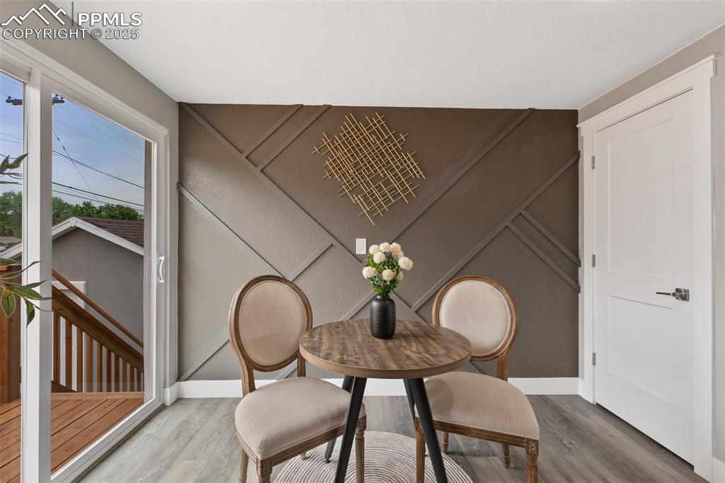 Image 6 of 18: Dining space with wood finished floors and baseboards