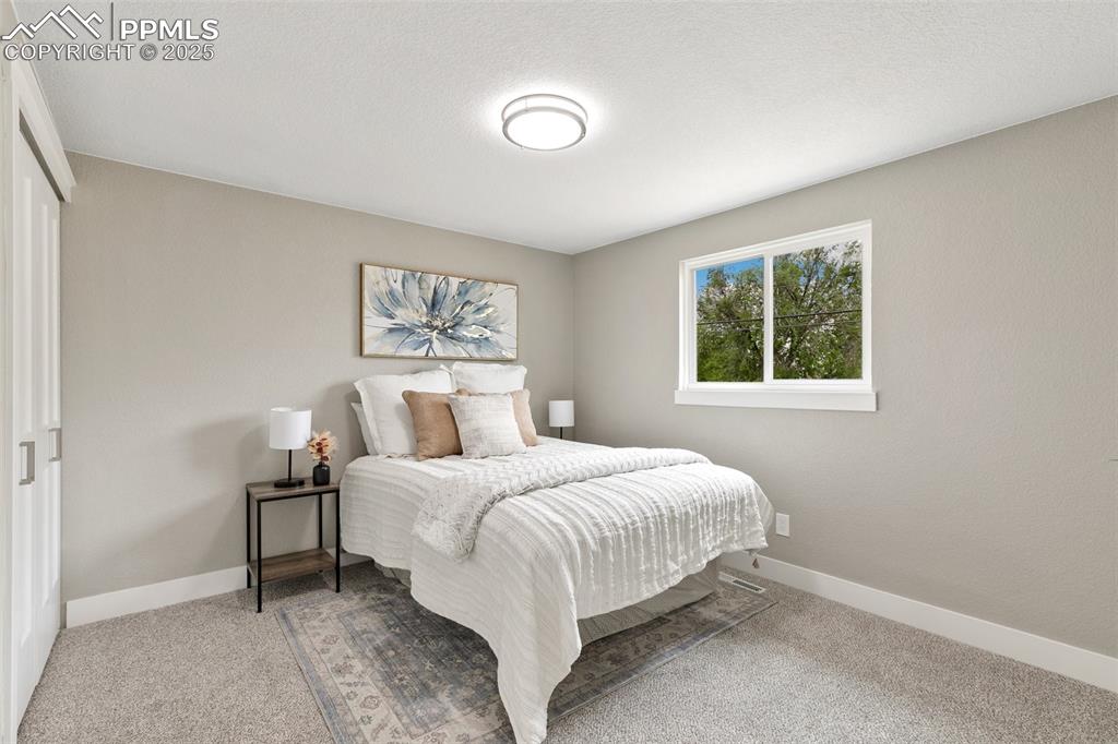 Image 9 of 18: Carpeted bedroom featuring baseboards