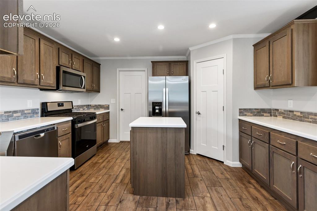 Image 10 of 45: Kitchen with island and pantry.