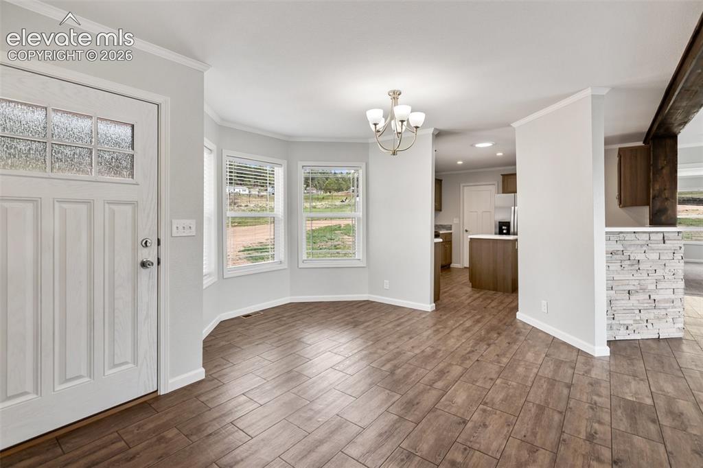 Image 2 of 45: Entry and dining room and kitchen