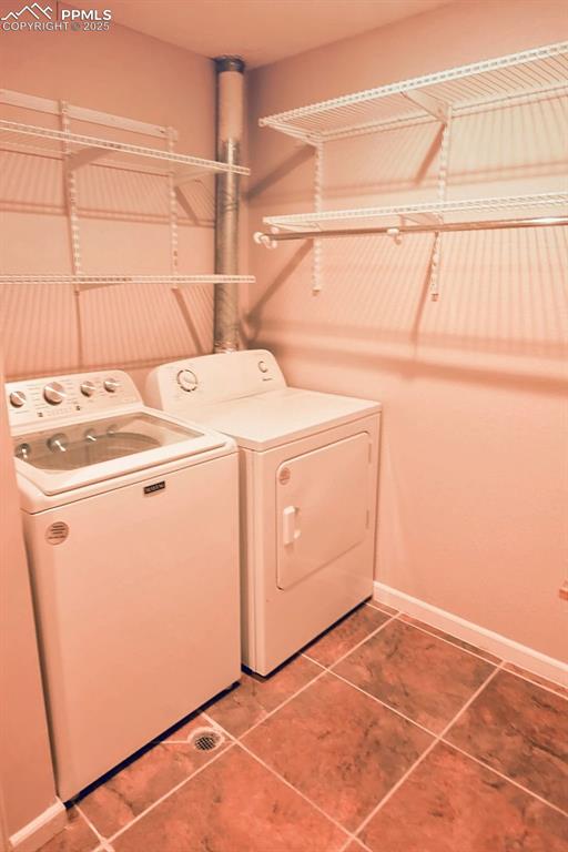 Image 26 of 38: Basement Laundry Area with Shelving