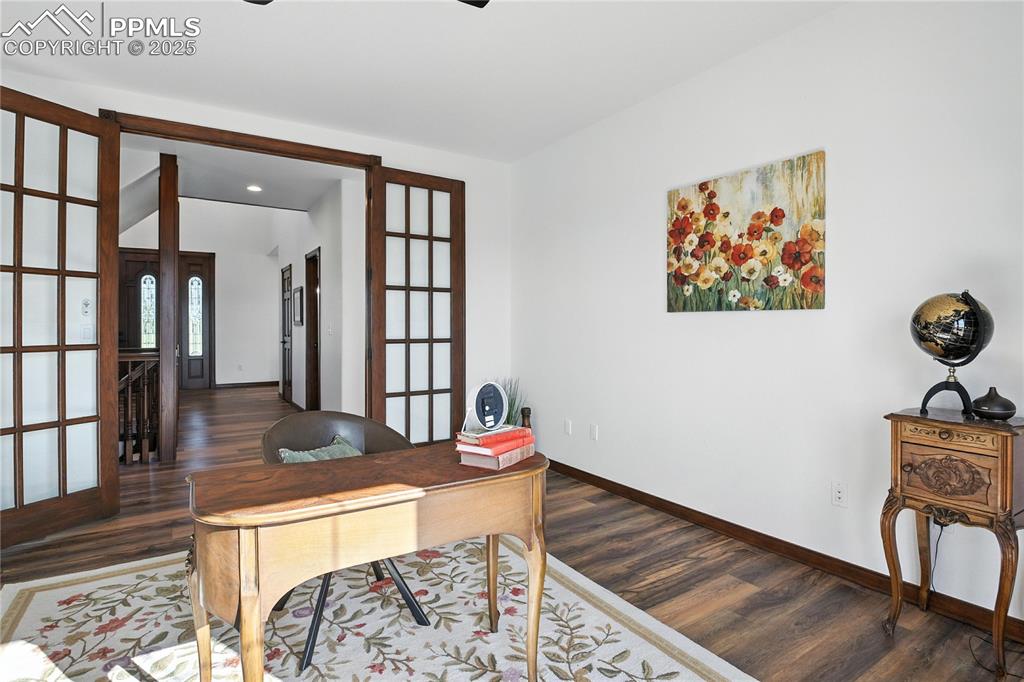 Image 31 of 50: Home office featuring dark wood-style flooring, french doors, and recessed