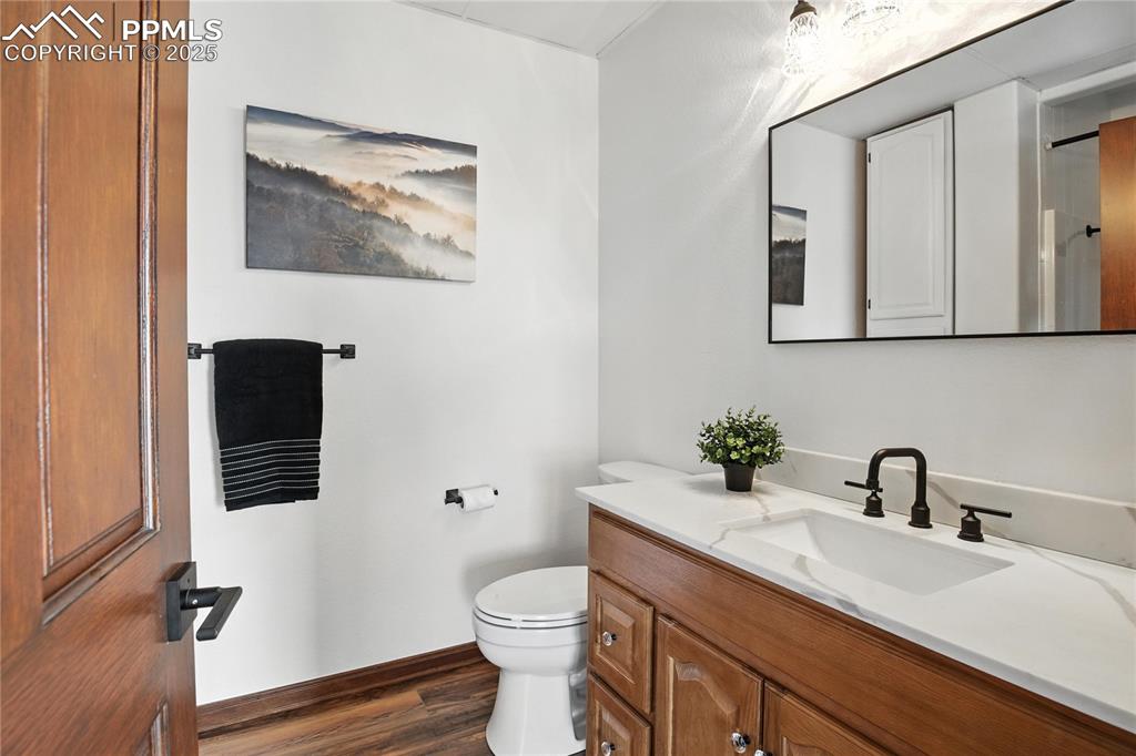 Image 37 of 50: Bathroom with vanity and wood finished floors