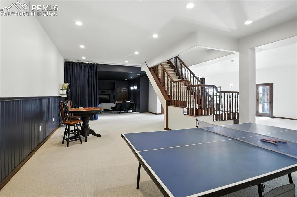 Image 39 of 50: Rec room featuring carpet floors, recessed lighting, and a fireplace