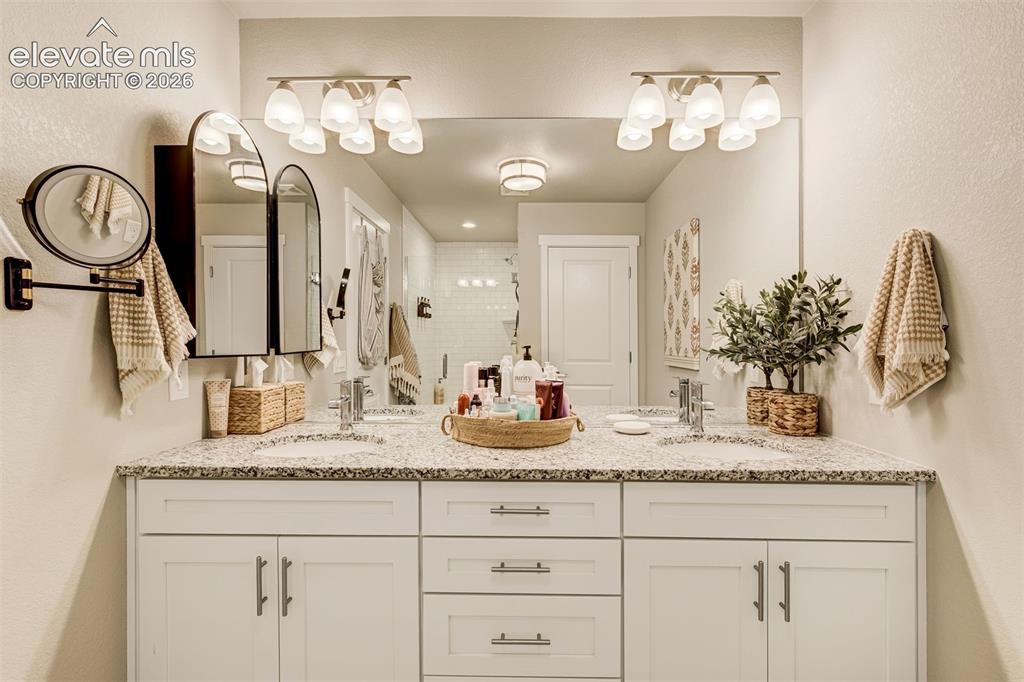 Image 26 of 49: Dual vanity in the attached primary bathroom