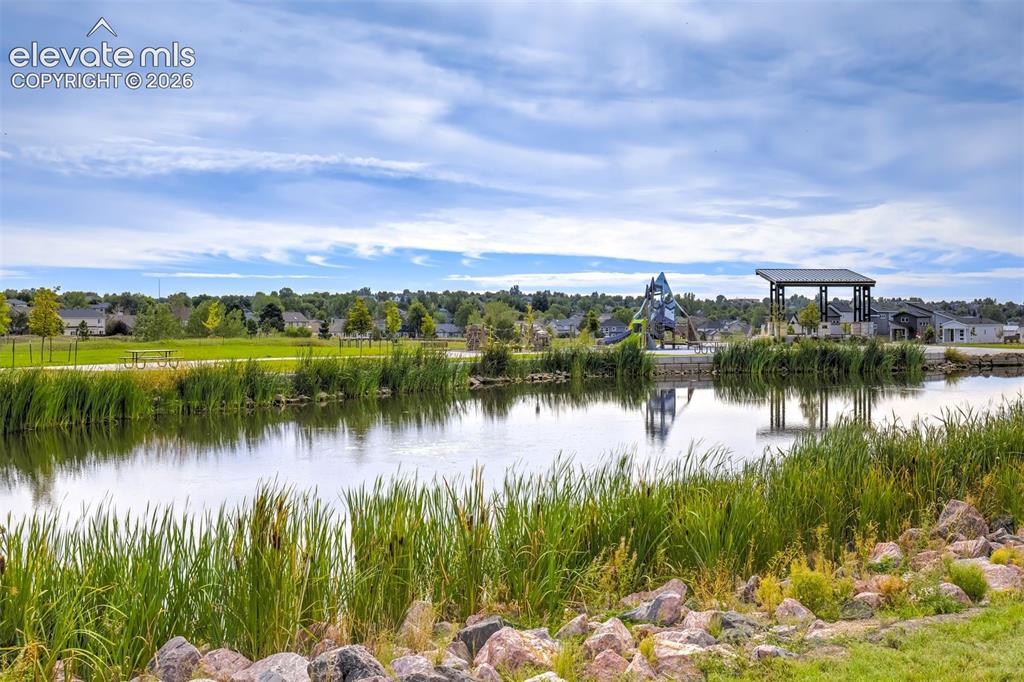 Image 40 of 49: Beautiful pond, park, and event pavilion with walking path