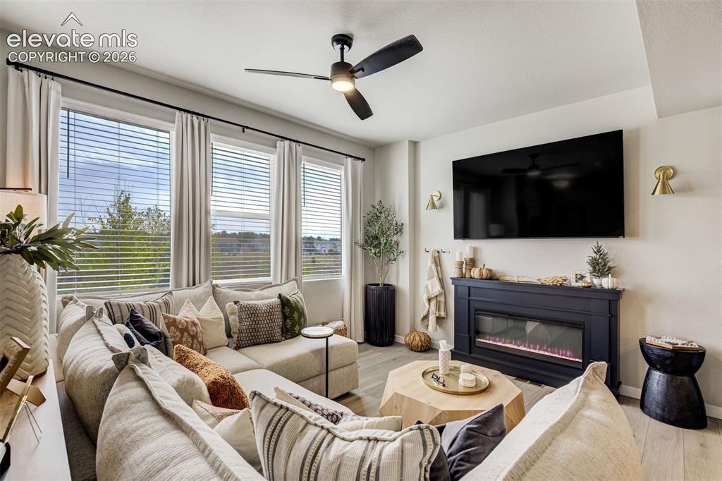 Image 6 of 49: Electric fireplace with remote. Wall sconces are rechargeable.