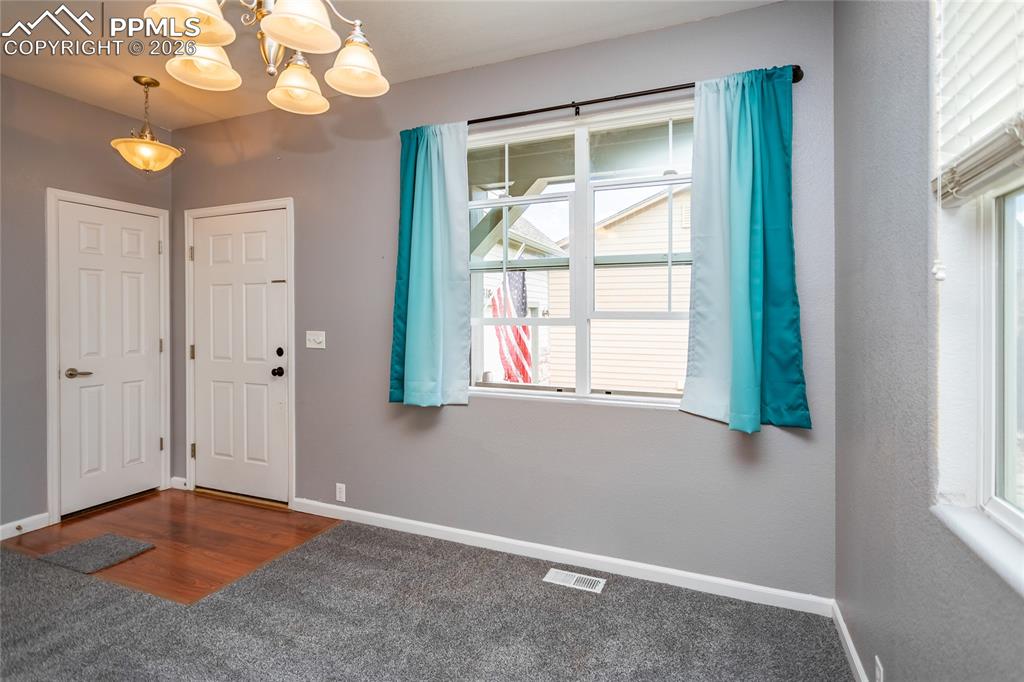 Image 10 of 43: Looking at front door and coat closet.