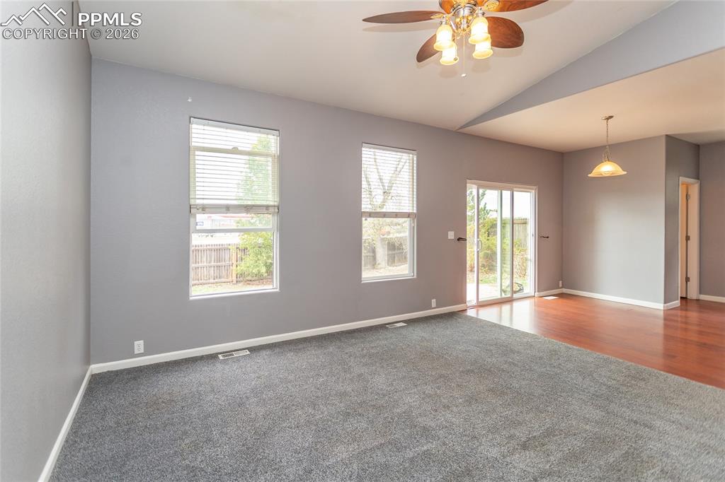 Image 13 of 43: Living room opens to kitchen