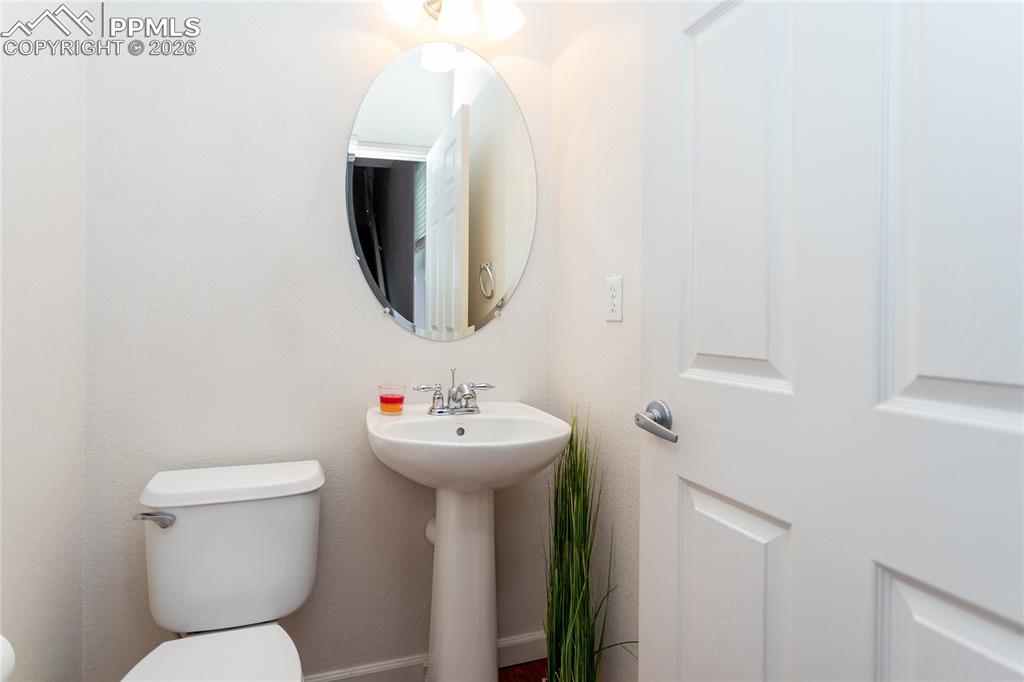 Image 17 of 43: 1/2 bathroom on main level next to kitchen