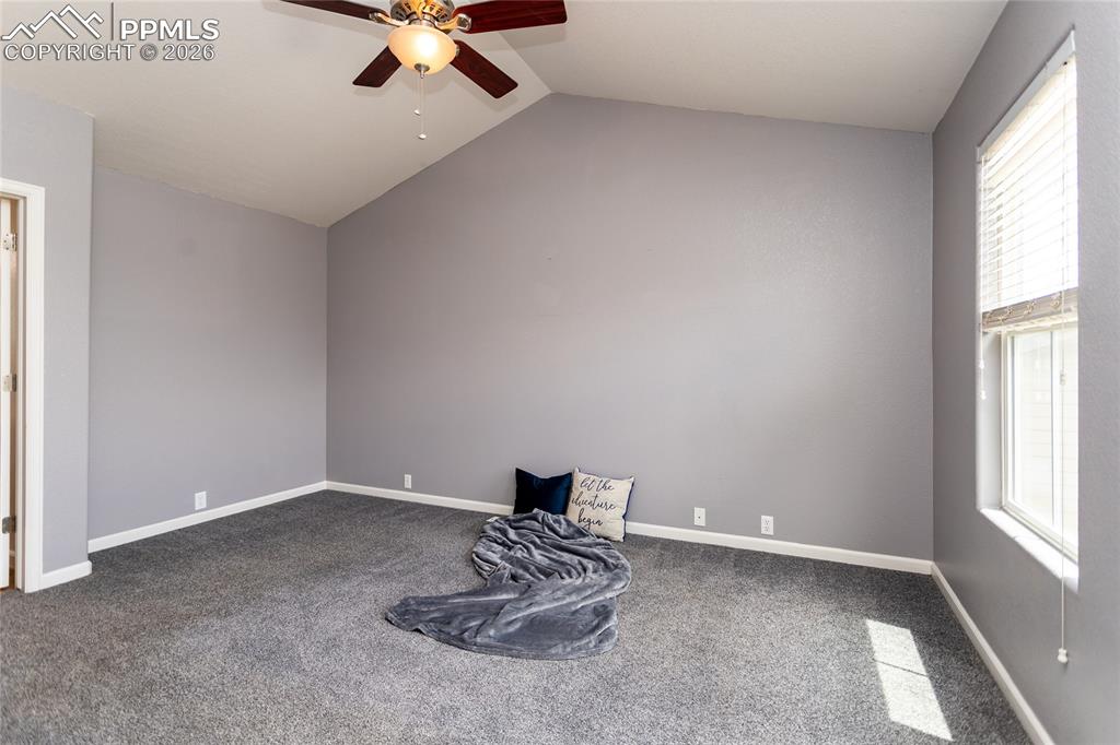 Image 23 of 43: Primary bedroom upstairs with vaulted ceilings
