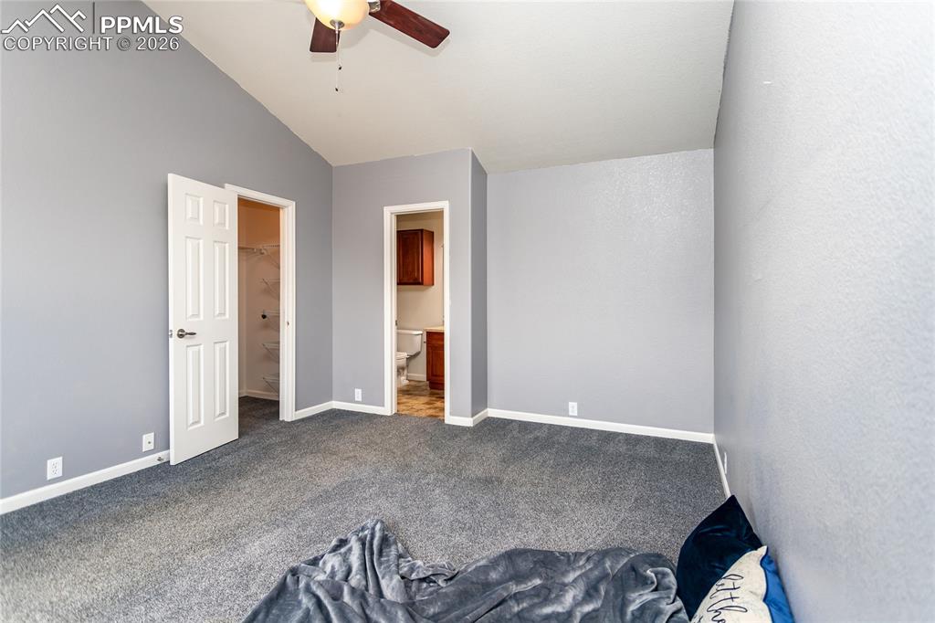 Image 24 of 43: Walk-in closet door to the left, en suite bath to the right.