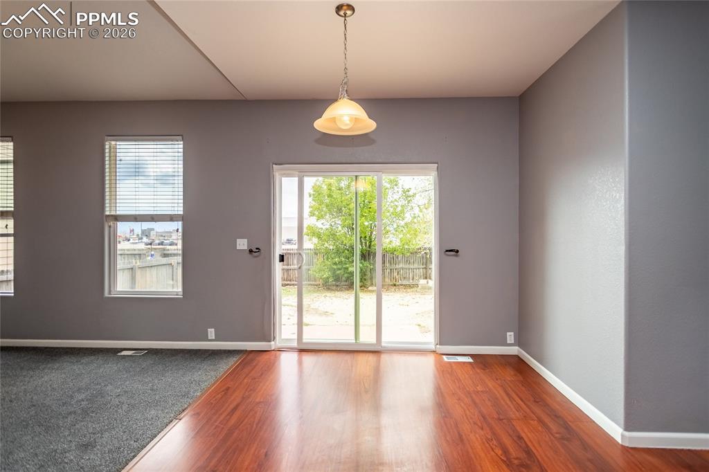 Image 36 of 43: Eat in kitchen area with slider out to backyard.