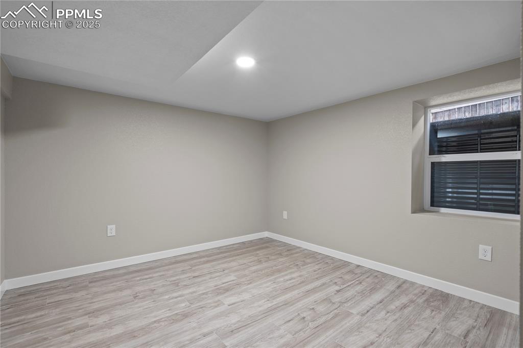 Image 11 of 26: Spare room with wood finished floors, baseboards, and recessed lighting
