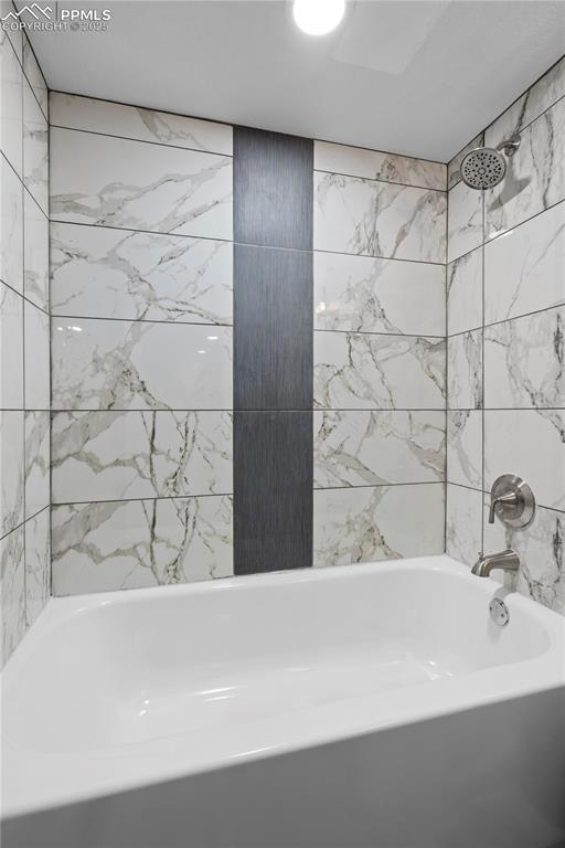 Image 13 of 26: Bathroom featuring washtub / shower combination