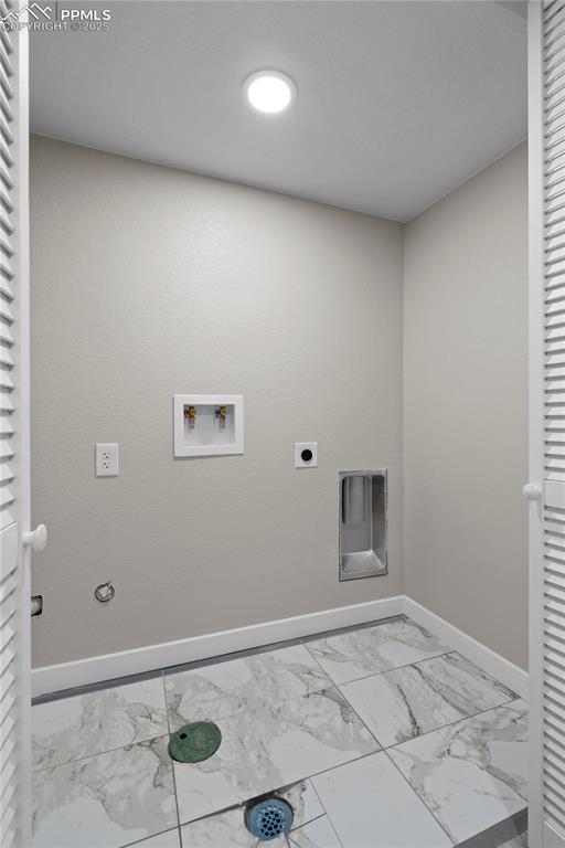Image 15 of 26: Washroom featuring marble finish flooring, hookup for a washing machine, ba