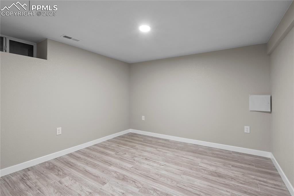 Image 16 of 26: Unfurnished room with light wood-type flooring, baseboards, and recessed li