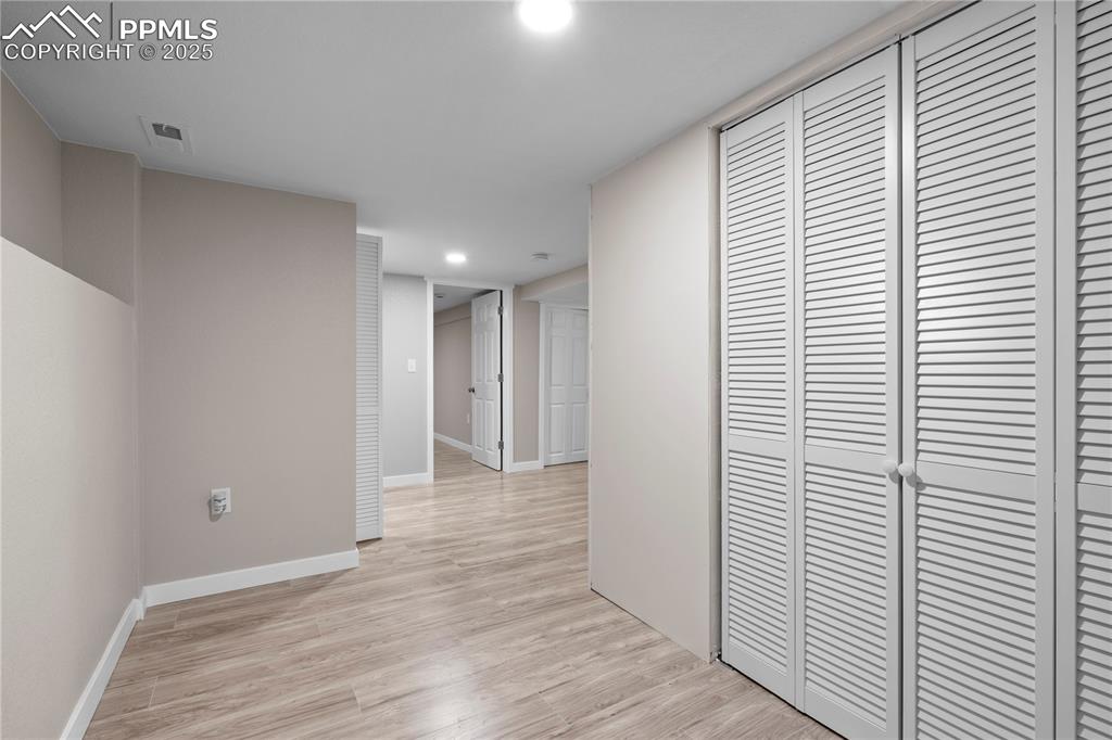 Image 17 of 26: Corridor featuring light wood-style floors, recessed lighting, and baseboar