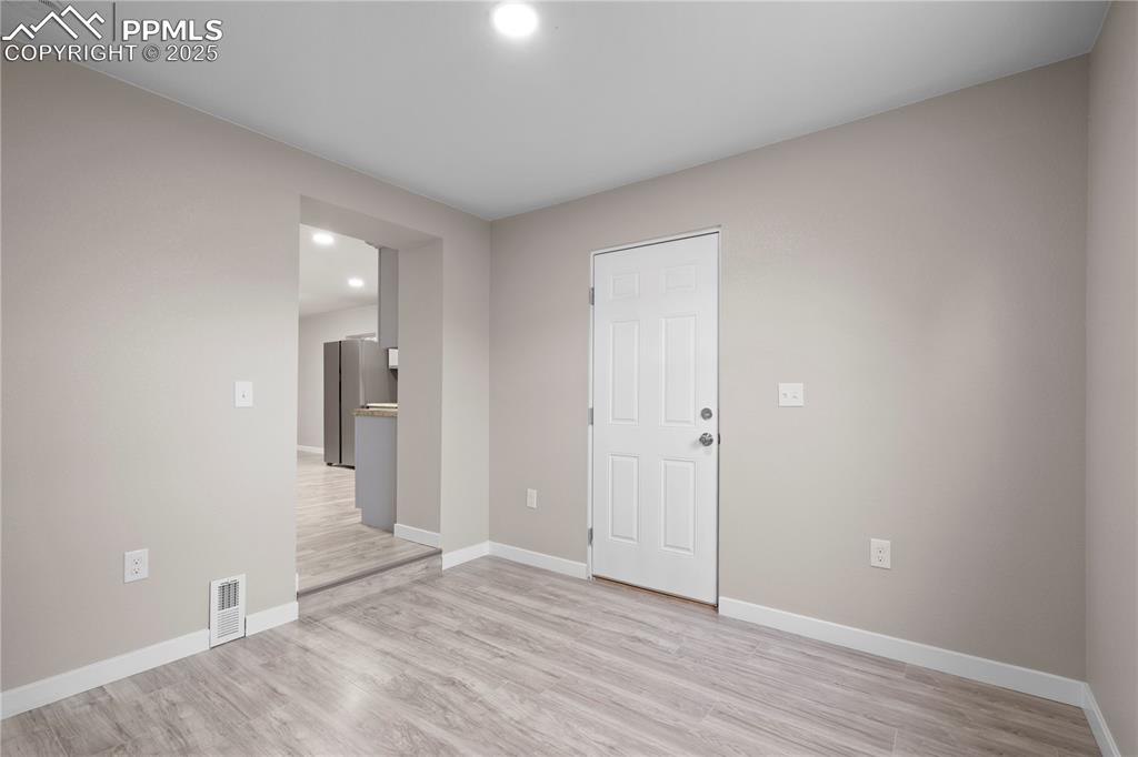 Image 18 of 26: Unfurnished room featuring recessed lighting, light wood finished floors, a