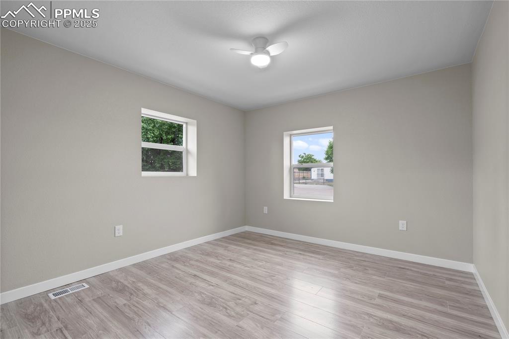 Image 21 of 26: Spare room featuring healthy amount of natural light, light wood-style floo