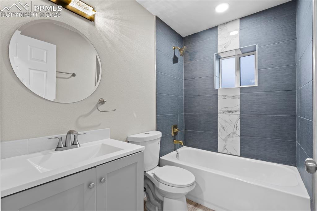 Image 23 of 26: Bathroom with vanity, toilet, and bathtub / shower combination