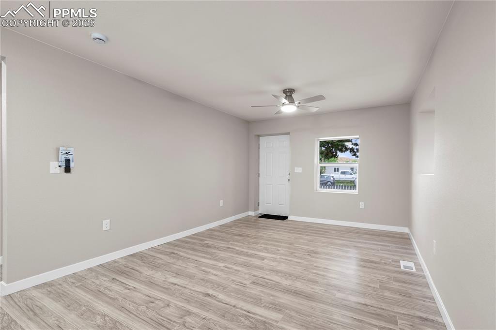 Image 6 of 26: Unfurnished room featuring ceiling fan, a smoke detector, light wood finish