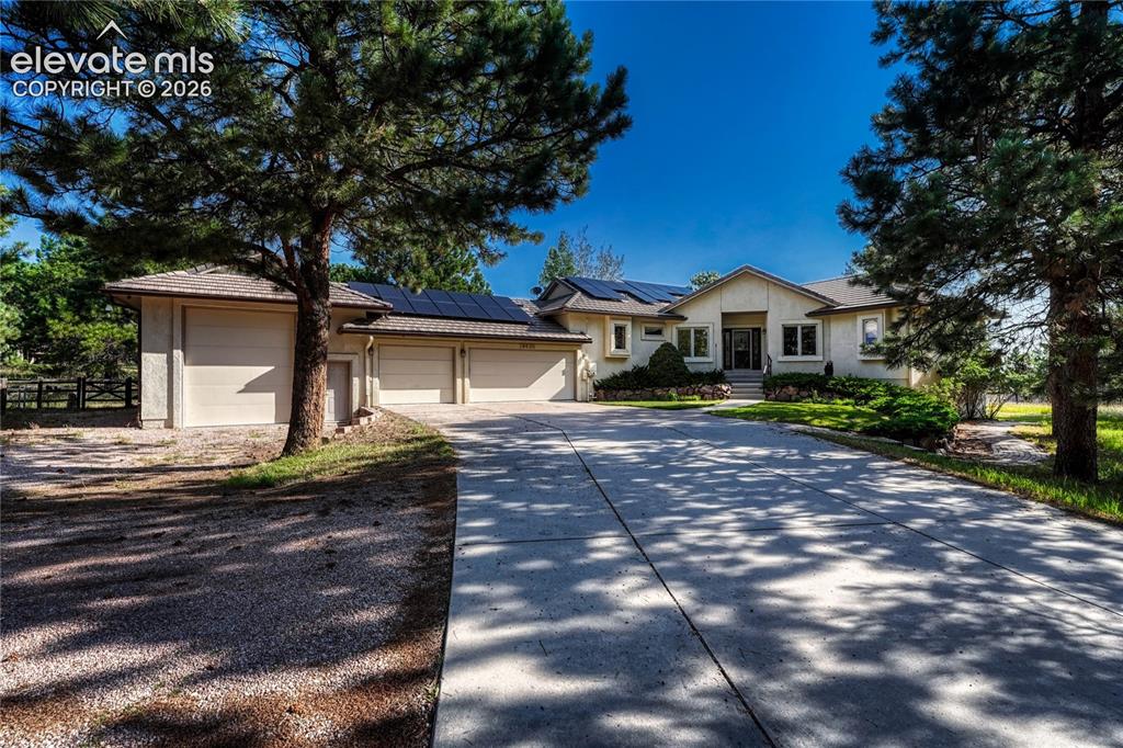 Image 11 of 50: Concrete driveway with a half circle turnaround.