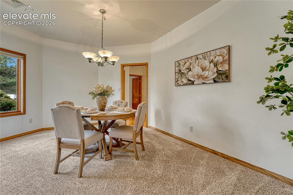 Image 16 of 50: Dining room just off the kitchen.