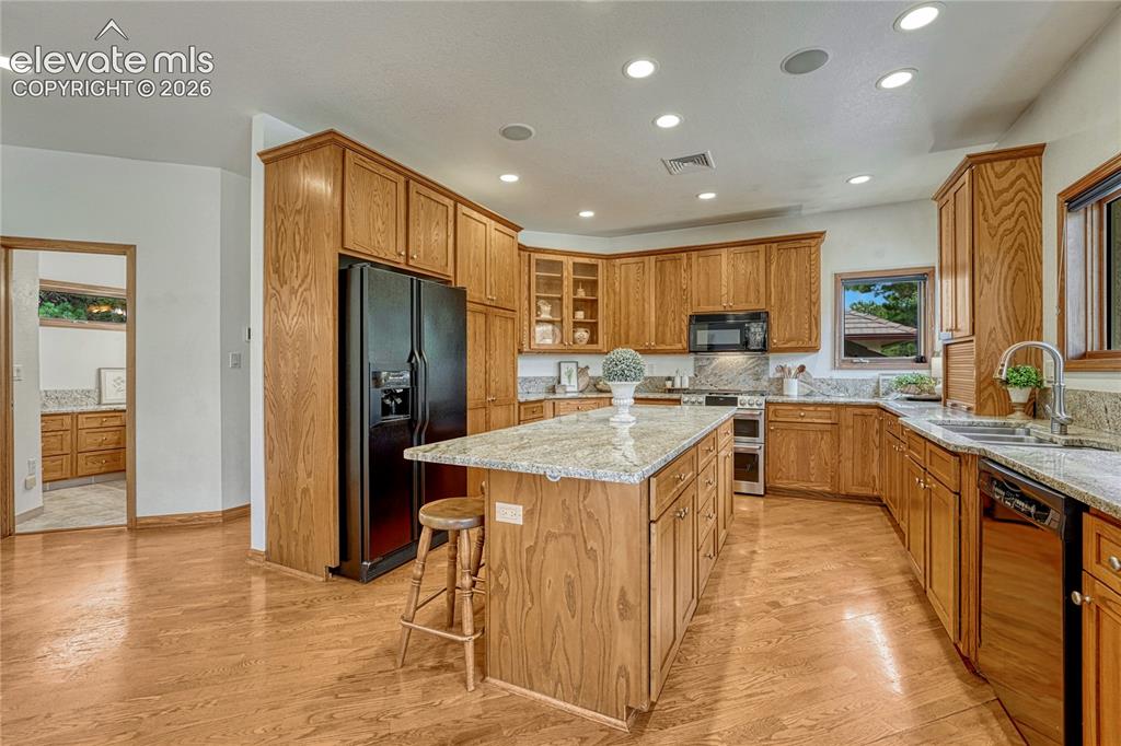 Image 18 of 50: Spacious kitchen with abundant storage, roll out shelving, recessed lightin