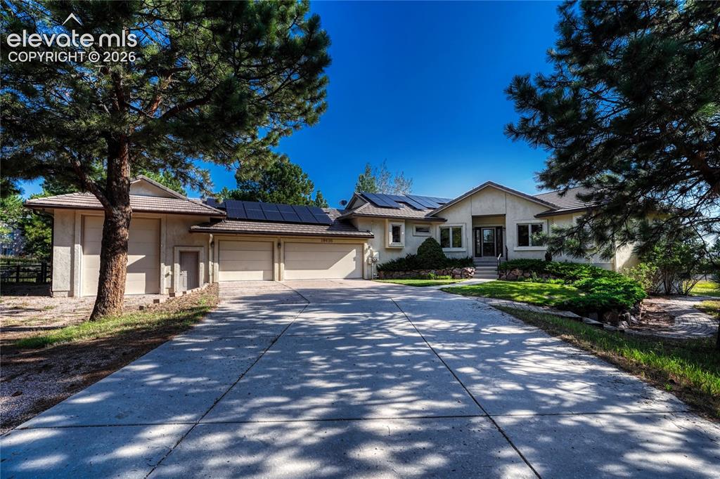 Image 2 of 50: Stucco exterior with concrete tile roof, paid off solar, and 2.5 acres.