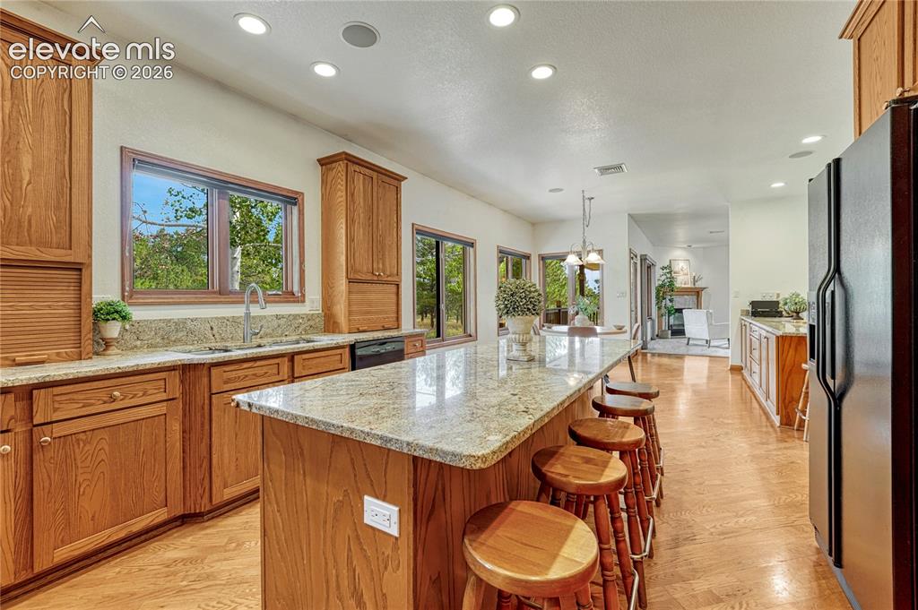 Image 20 of 50: Kitchen opens to the breakfast nook and living room.  Window over kitchen s