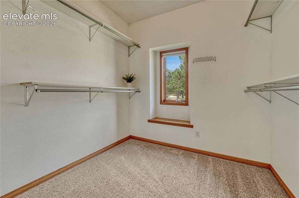 Image 30 of 50: Primary walk-in closet.