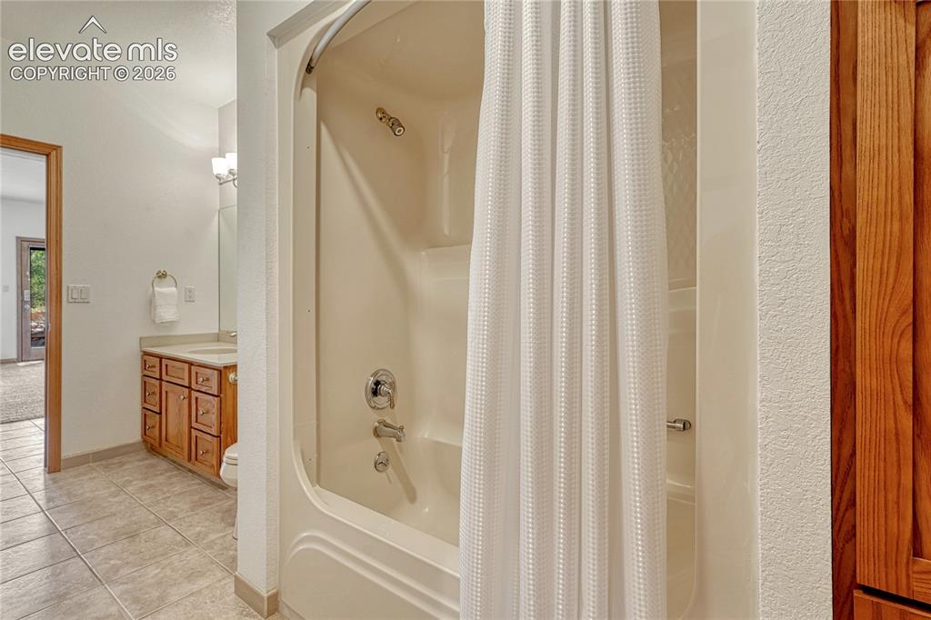 Image 41 of 50: Lower level bath with tub and shower.