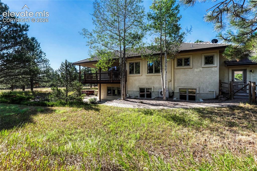 Image 46 of 50: Back of the home and fenced in area for dogs.