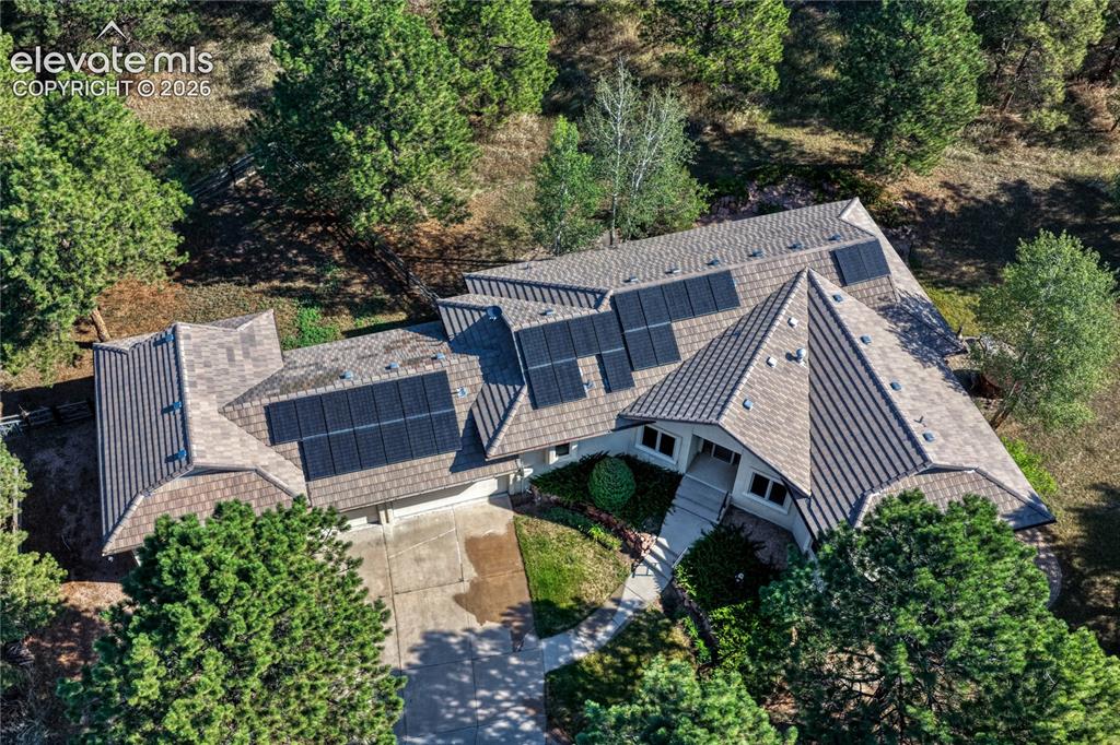 Image 47 of 50: Aerial view showing the paid off solar and concrete tile roof.
