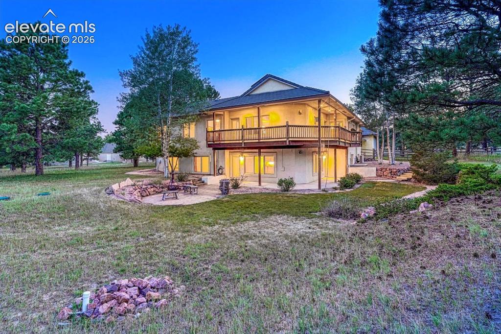 Image 50 of 50: Sunset view of the rear of the home and patios.