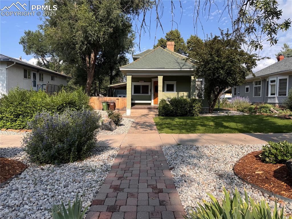 Caption: View of the front of the house and yard.