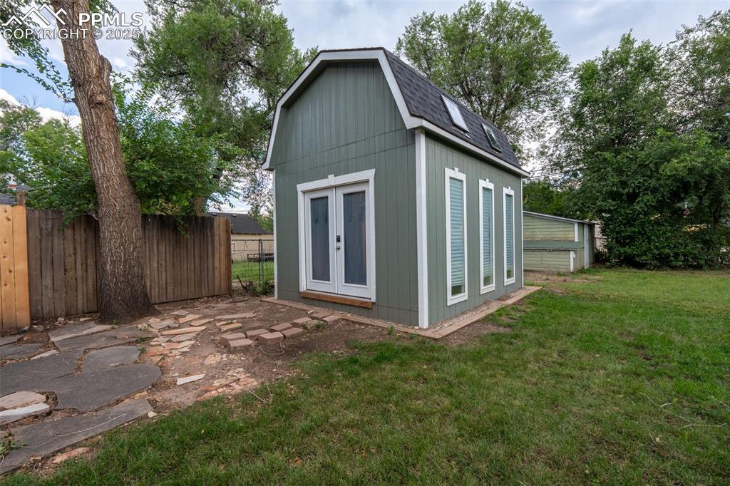Image 28 of 29: Backyard view from the Patio towards the back of the property and office/sh