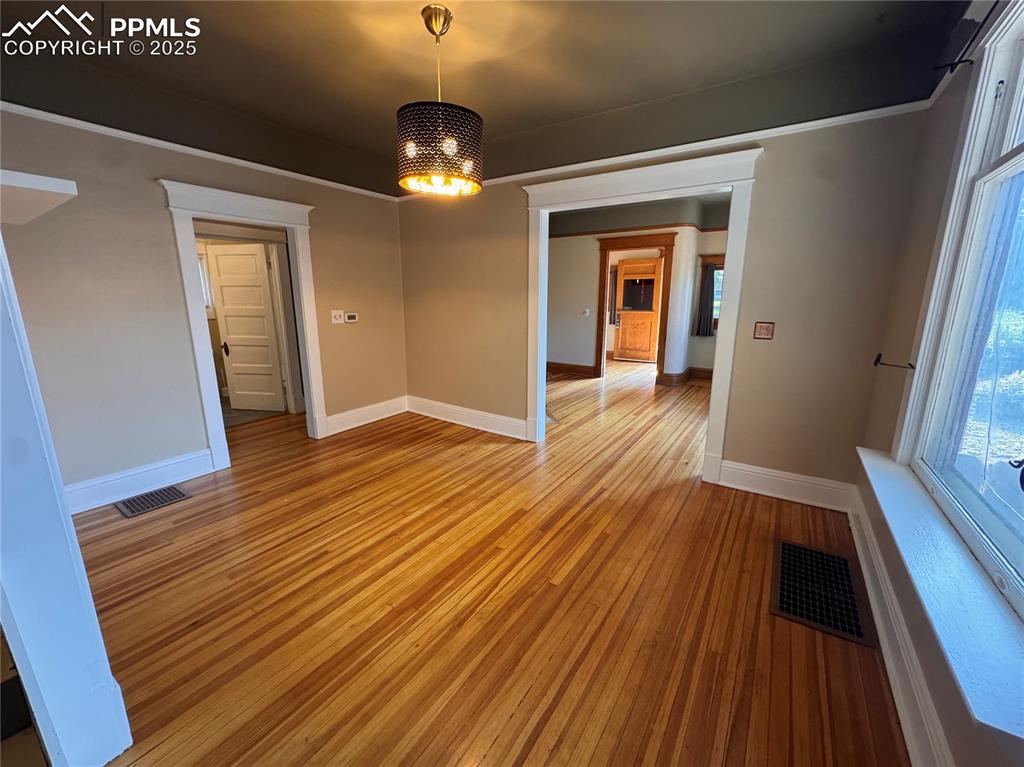 Image 5 of 16: Unfurnished dining area with light wood-style flooring and baseboards